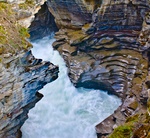 Bowl shape cut into rock by swirling Athabasca Falls